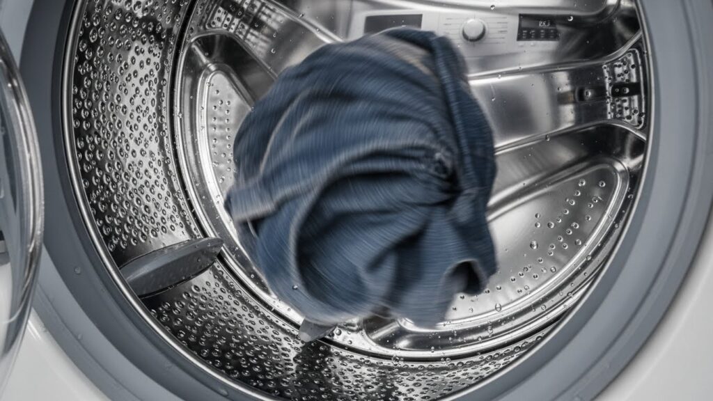 Washer drum with one heavy item stuck to one side illustrating an unbalanced load during spin